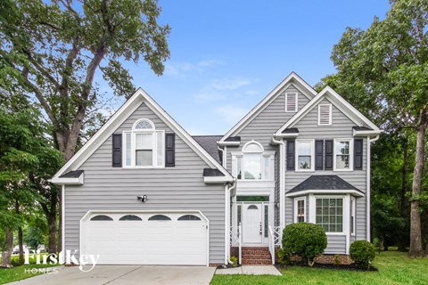 a gray house with a white garage door