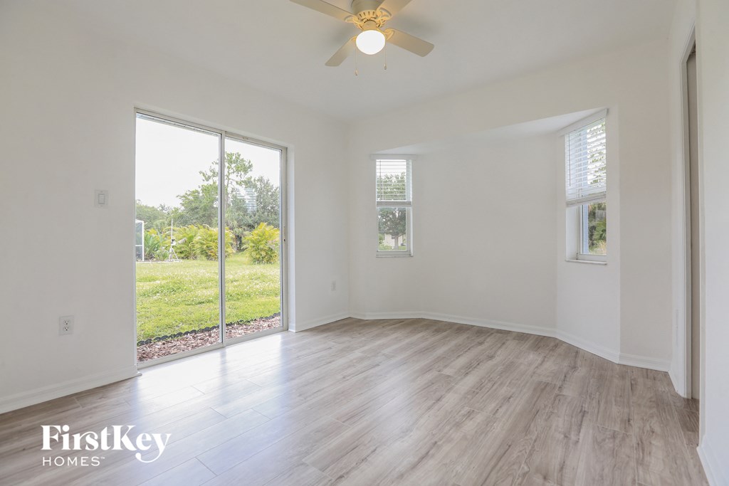 an empty living room with white walls and a sliding glass door