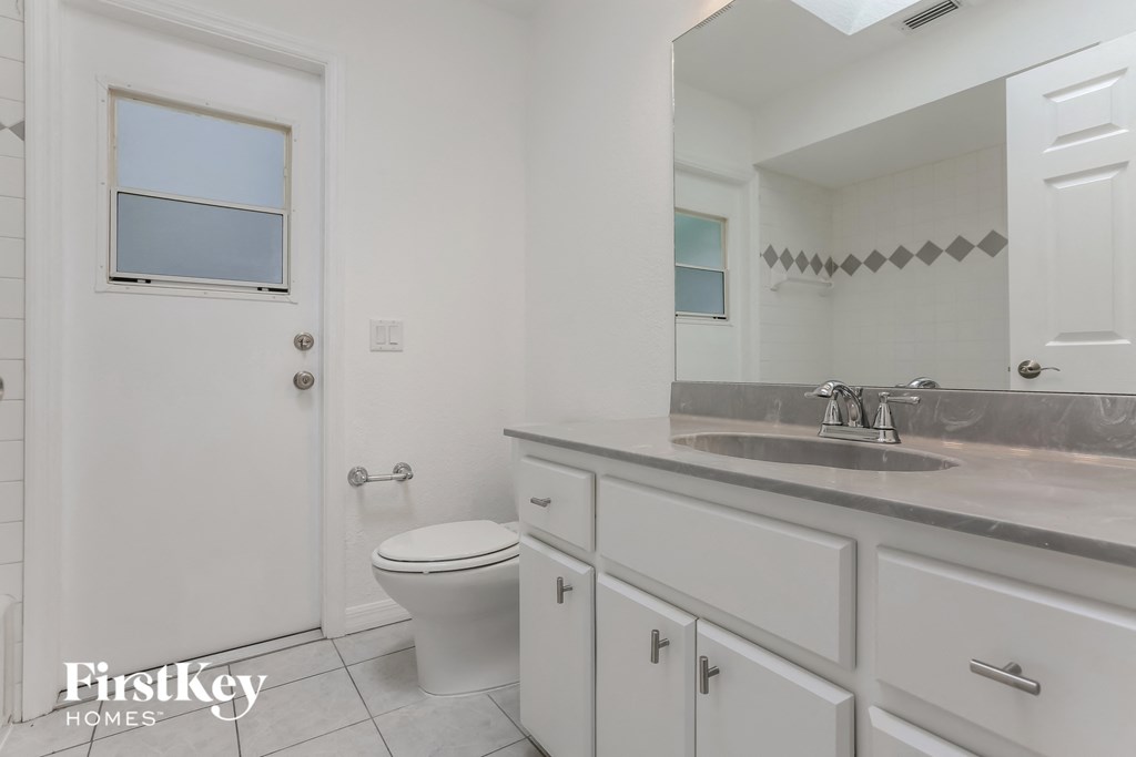 a white bathroom with a toilet and a sink