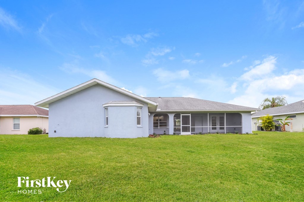 a white house with a lawn in front of it