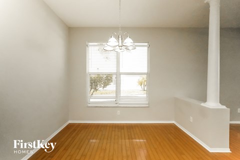 a living room with wood floors and a window