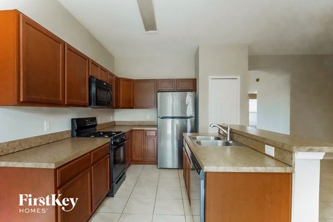 a kitchen with wooden cabinets and stainless steel appliances