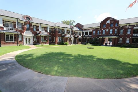 a large lawn in front of an apartment building