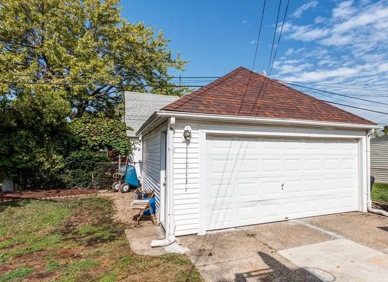 a small white garage with a white garage door