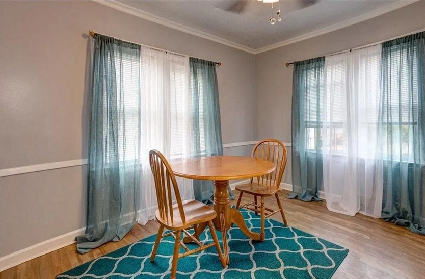 a dining room with a table and two chairs