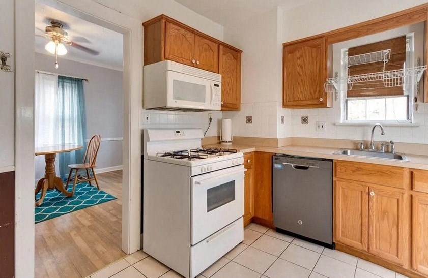 a kitchen with a stove and a dishwasher and a sink