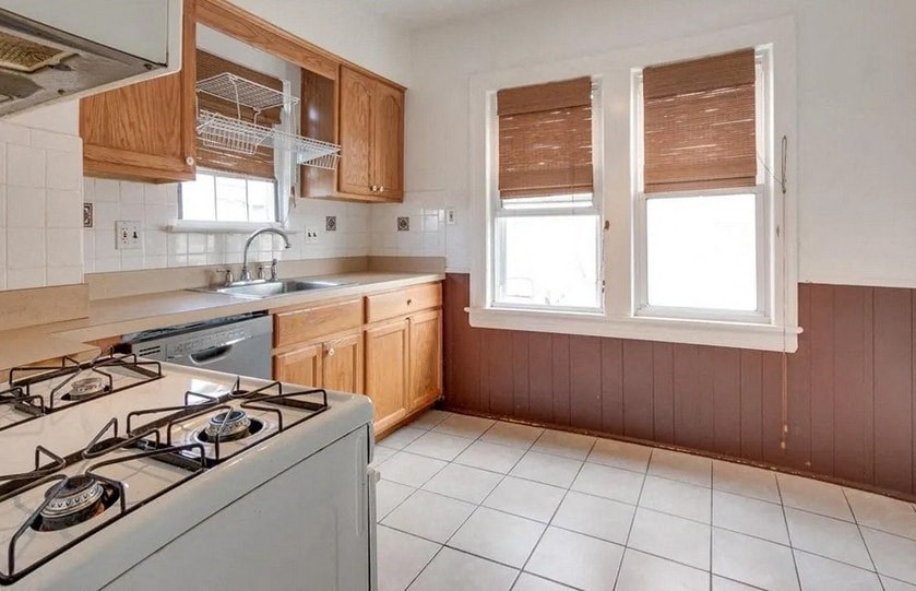 a kitchen with a stove top oven and a sink