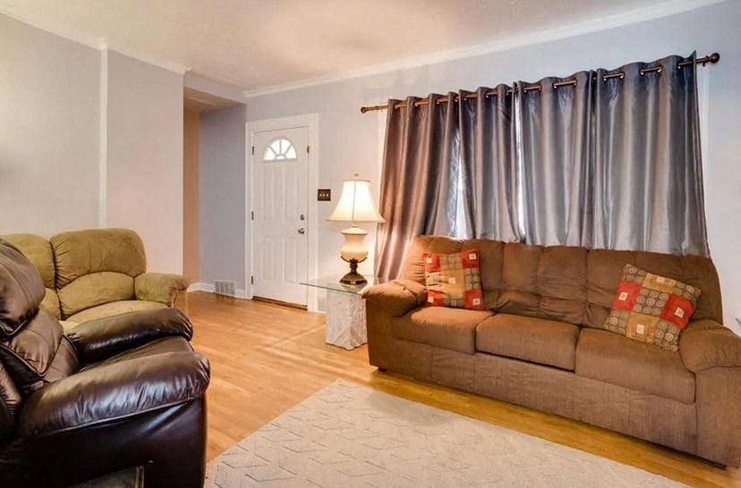 a living room with two couches and curtains