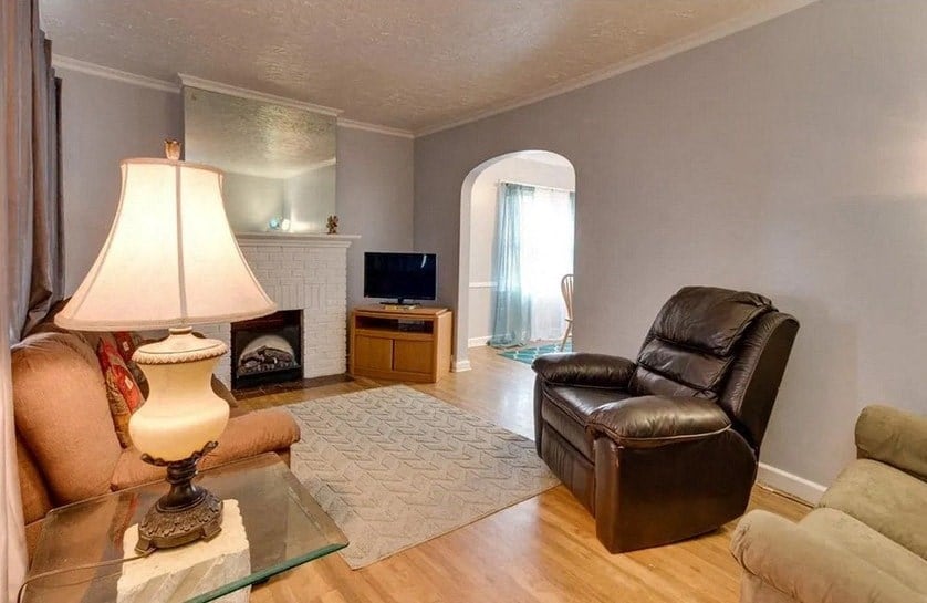 a living room with a leather chair and a table