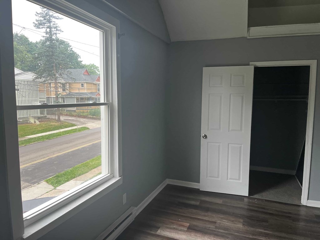 a living room with a large window and a white door