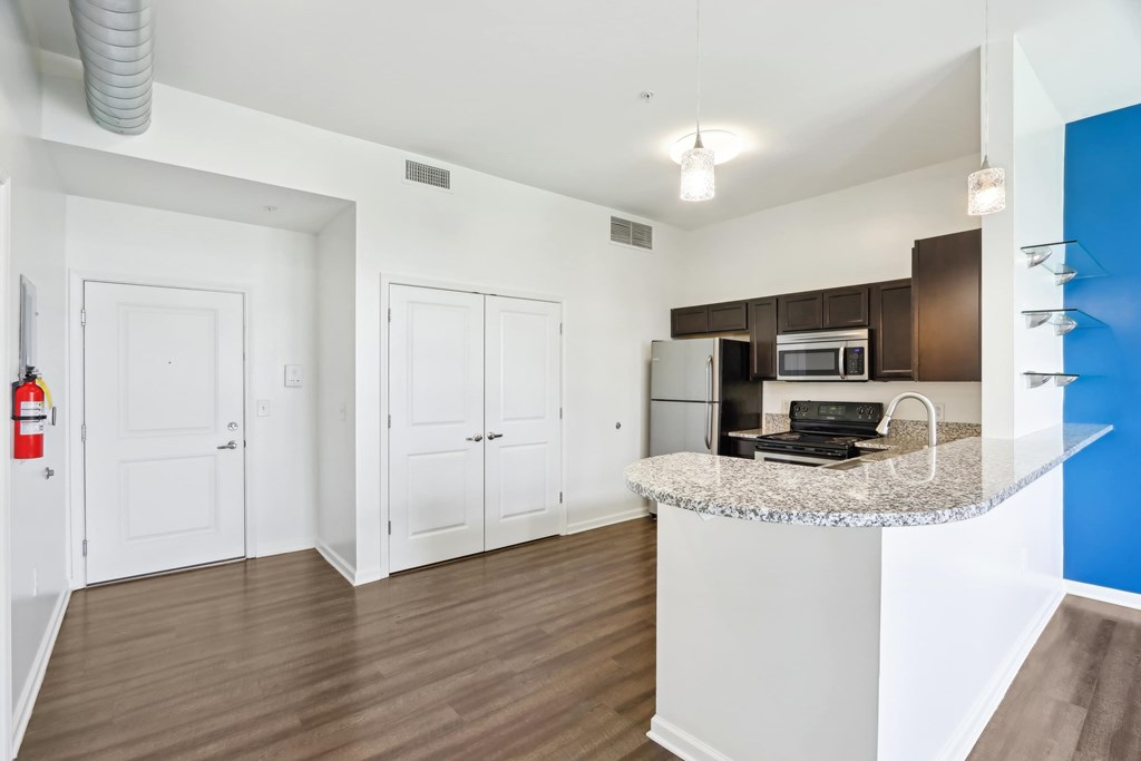 A kitchen area with a counter and cabinets.