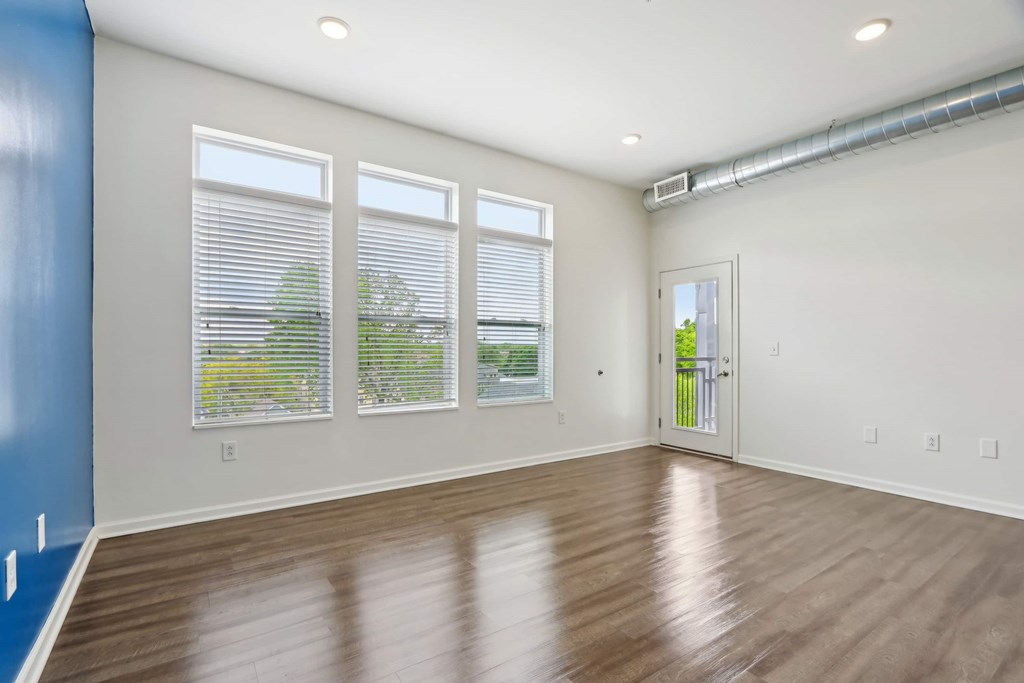 A room with a blue wall and wooden flooring.