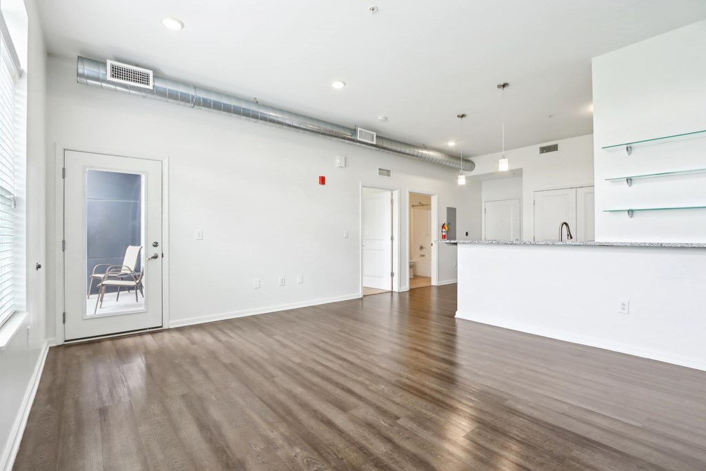 A room with wooden floors and white walls.
