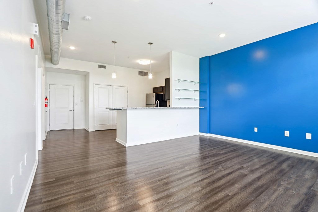 A room with a white counter and a blue wall.