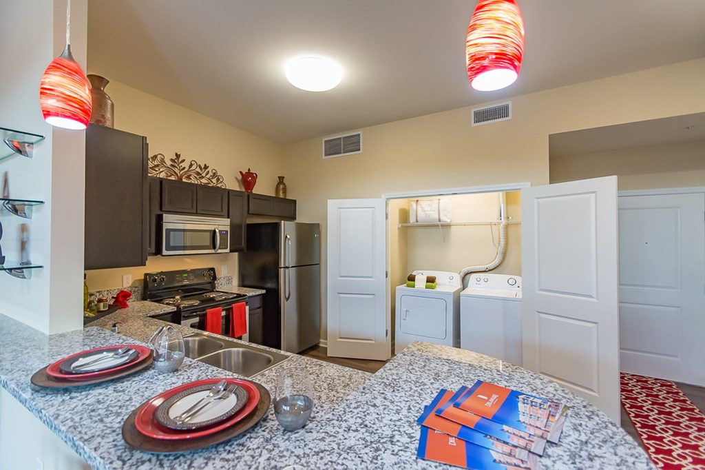 A kitchen with a table set for two.