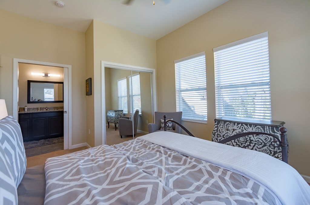 A bedroom with a large bed and a television in the corner.