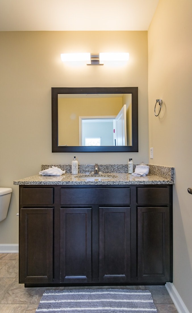A bathroom with a sink and a mirror.