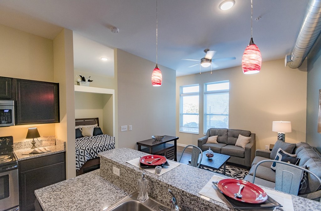 A modern kitchen and living room with a dining table and chairs.