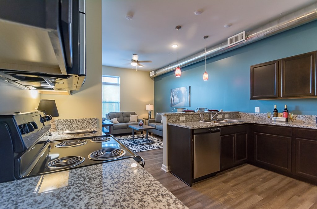 A modern kitchen with a stove top oven and a counter top.