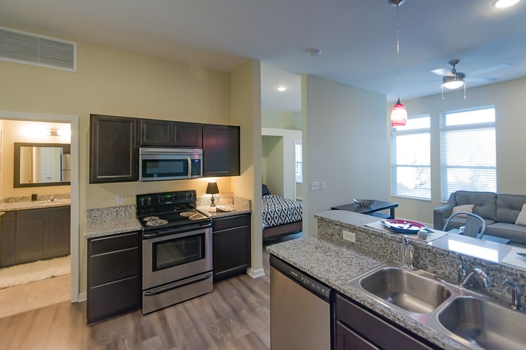 A kitchen with a stove, oven, and microwave.
