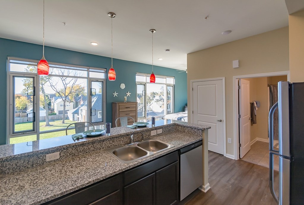 A kitchen with a granite countertop and a sink.