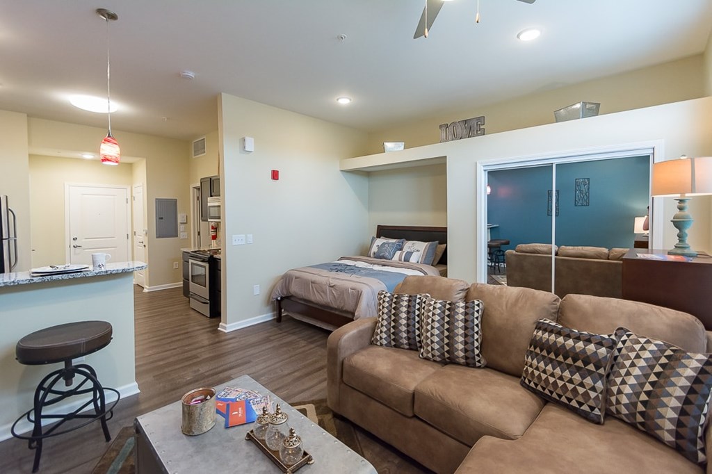 A living room with a couch and a bar area.