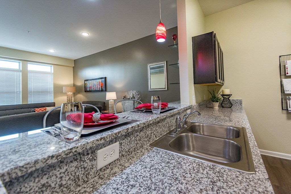 A kitchen with granite countertops and stainless steel appliances.