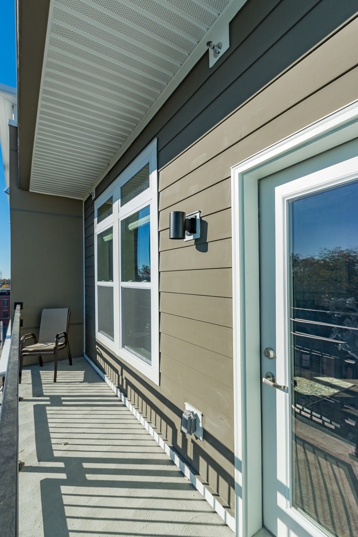 A patio with a sliding door and a window.