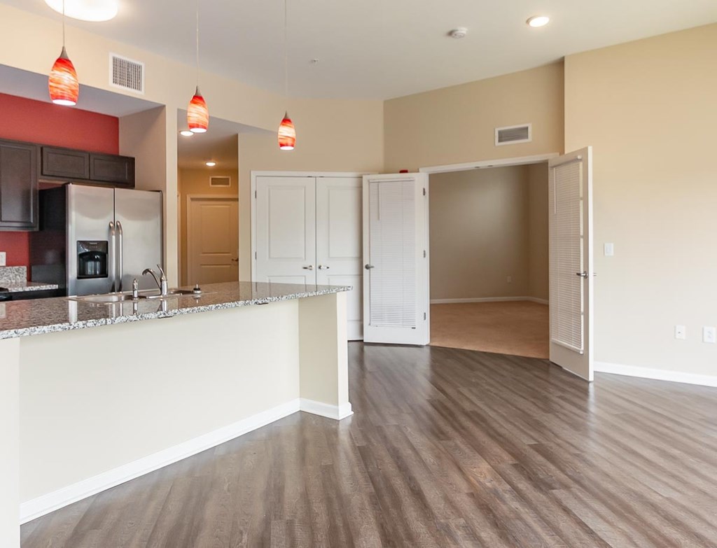 A kitchen with a white counter and a refrigerator.