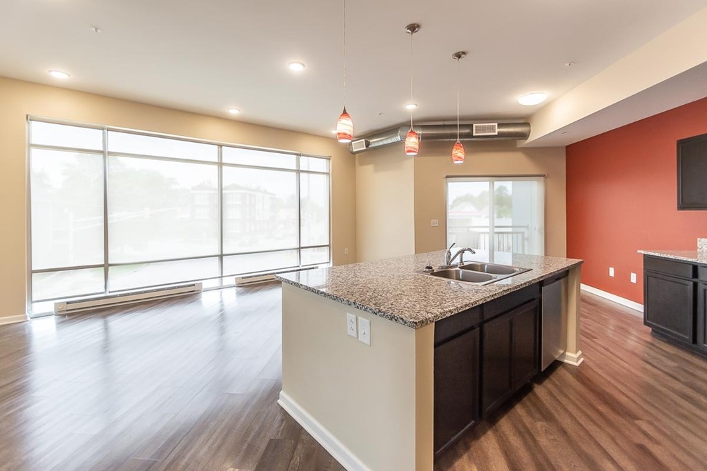 A kitchen area with a sink and a window.