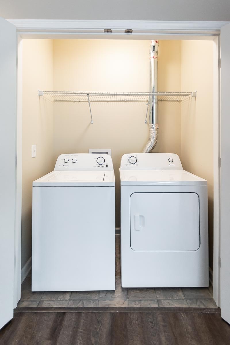 A white washing machine and dryer in a small laundry room.