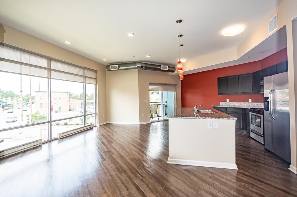 A kitchen with a white island in the middle of the room.