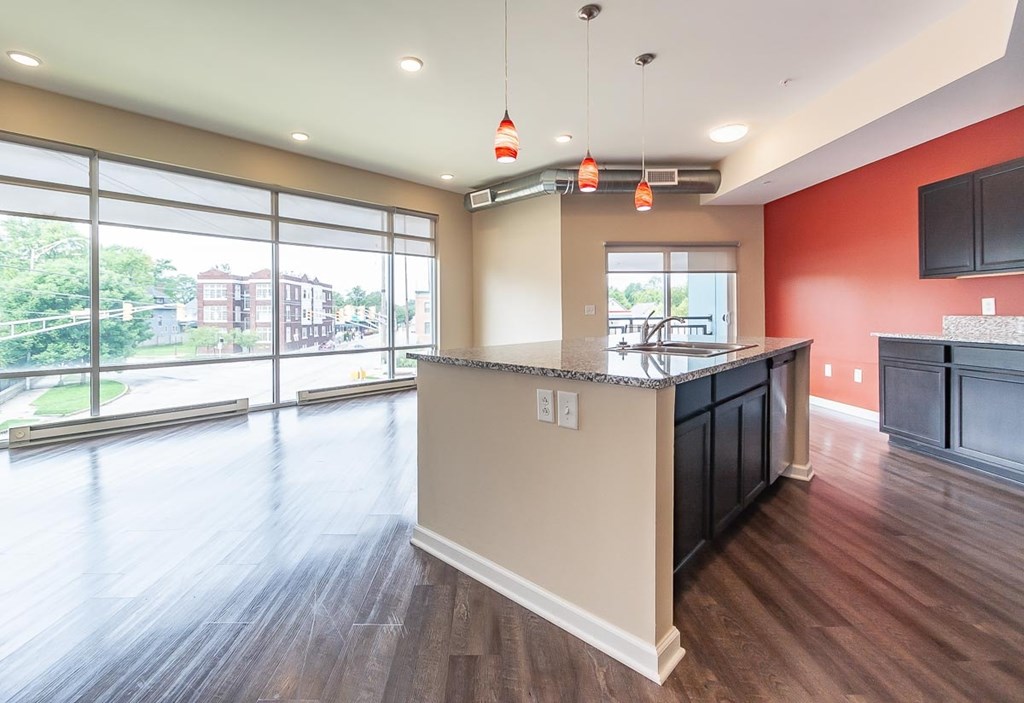 A kitchen with a large island and a view of a street.