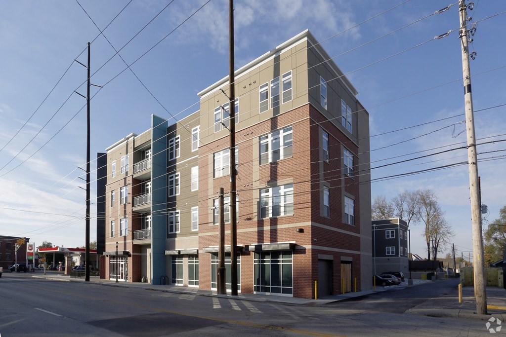 A large multi-story building with a mix of brick and panel siding.