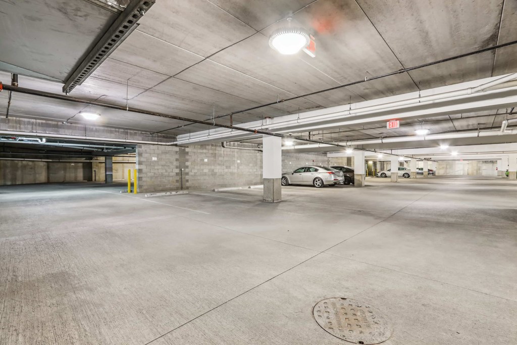 A parking garage with a car parked in the middle.