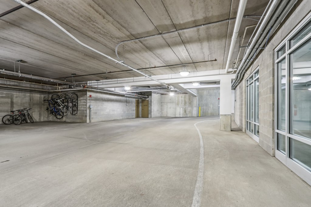 A spacious, empty parking garage with a concrete floor and walls.