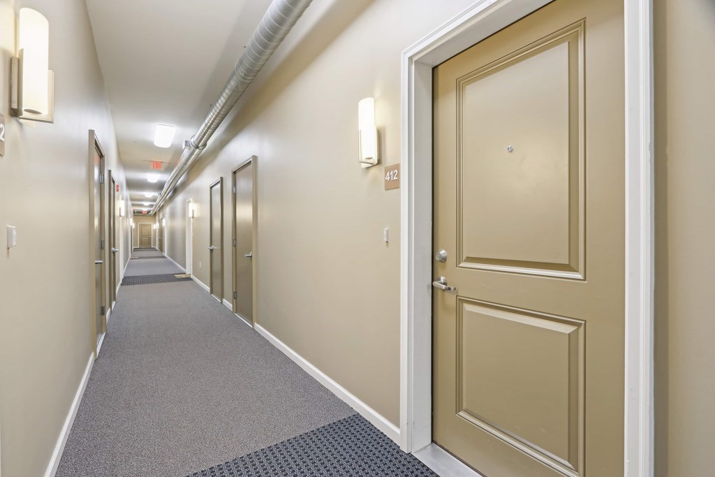 A long hallway with doors on both sides.