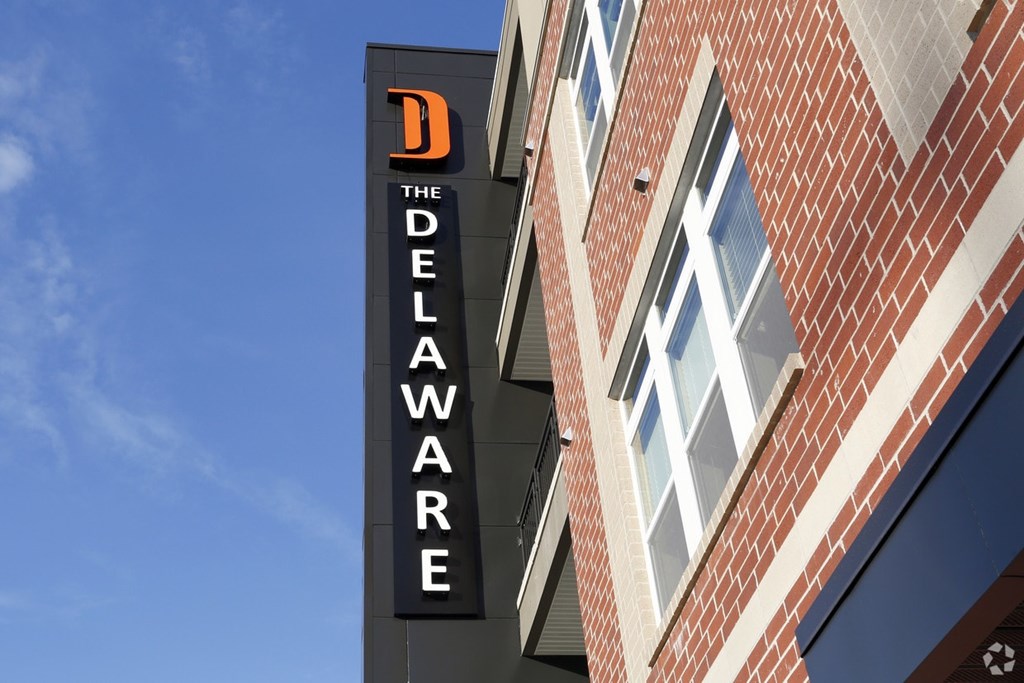 A sign for Delaware is on the side of a building.