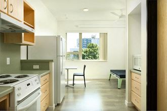 a kitchen with a stove refrigerator and a window