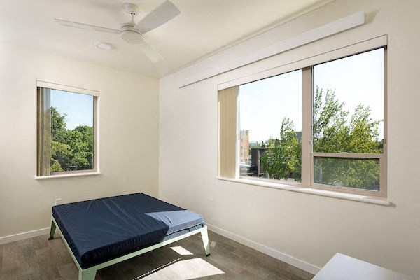 a room with a bed and a large window