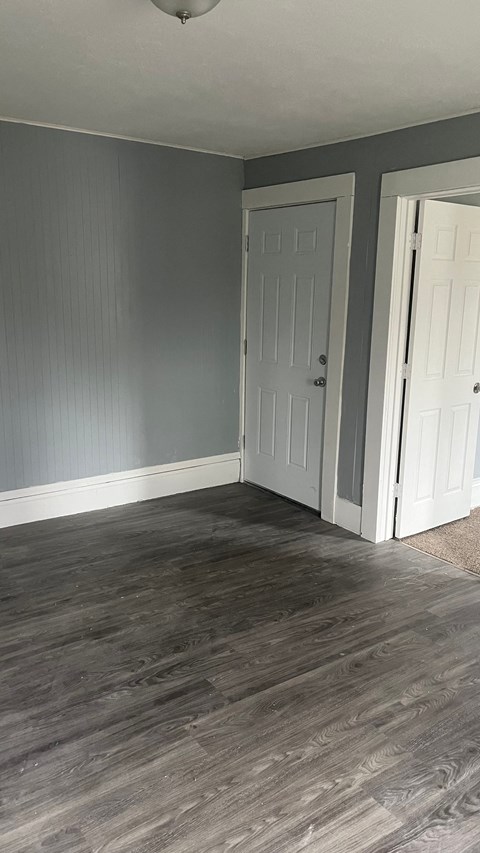 a living room with grey walls and a white door