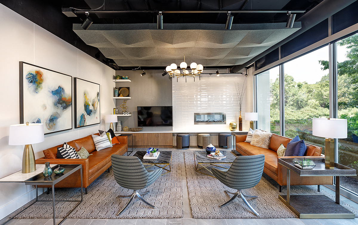 a living room with couches and chairs and a large window