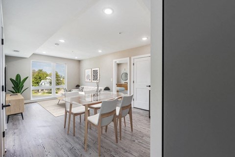 A dining room with a table set for four.