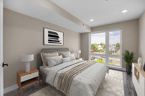 A bedroom with a large bed and a view of the outside.