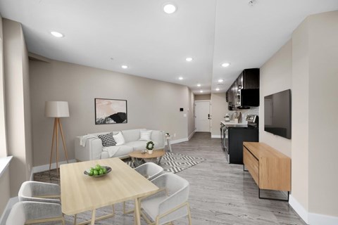 A modern living room with a dining table and chairs.