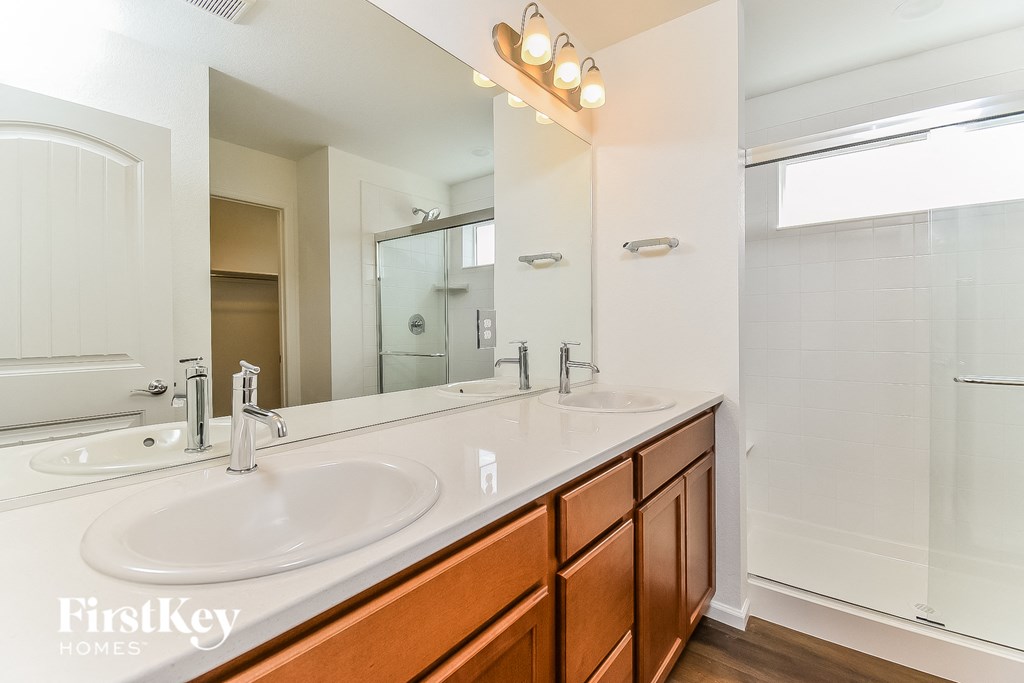 a bathroom with two sinks and a large mirror