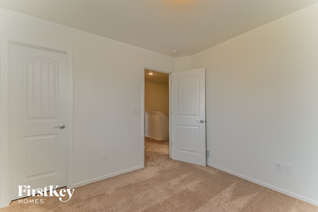 a bedroom with two closets and a door to a bathroom