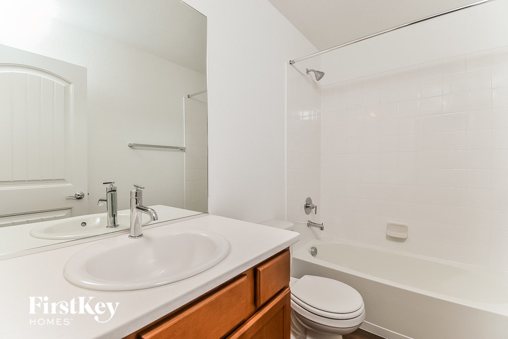a bathroom with a sink and a toilet and a shower