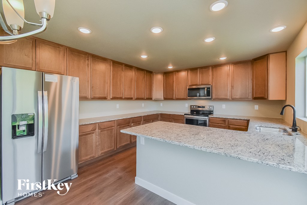 a kitchen with wooden cabinets and a granite counter top