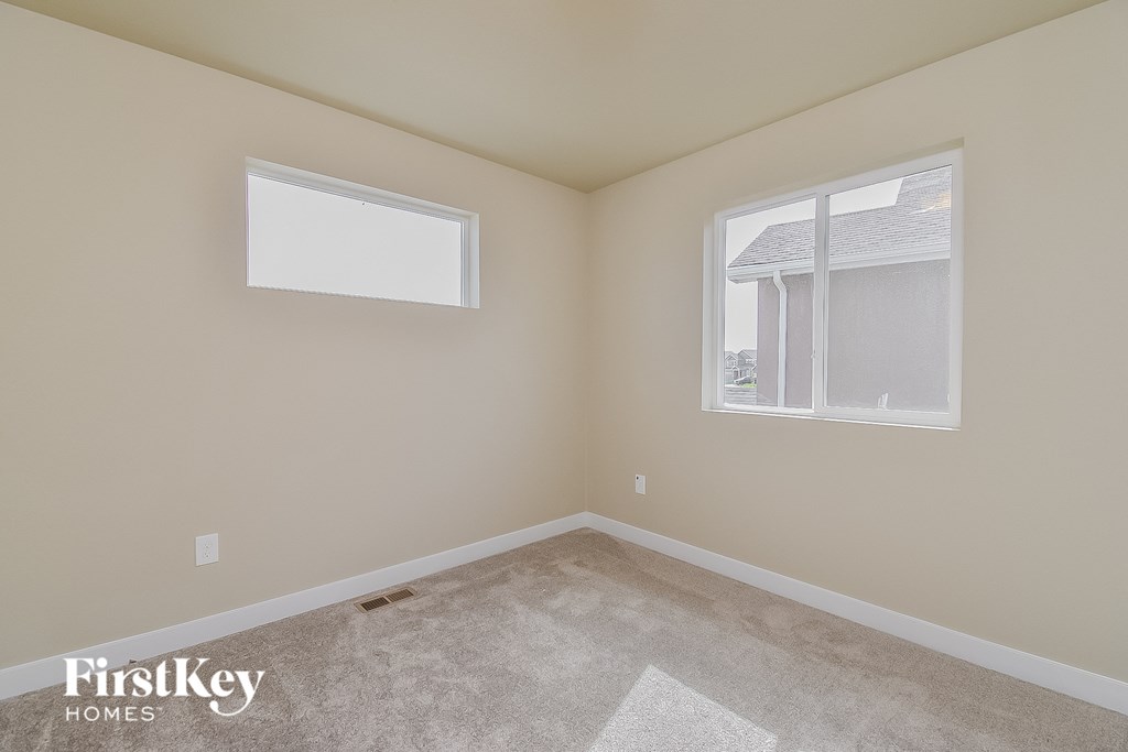 a bedroom with a carpeted floor and a window